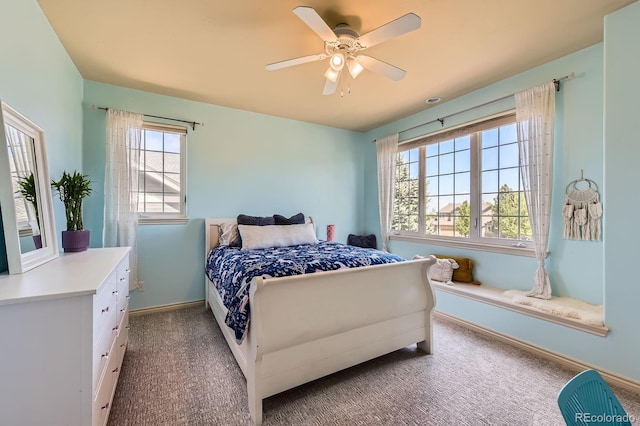 bedroom featuring multiple windows, carpet, and baseboards