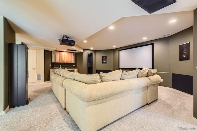 cinema room featuring light carpet, recessed lighting, a sink, and baseboards