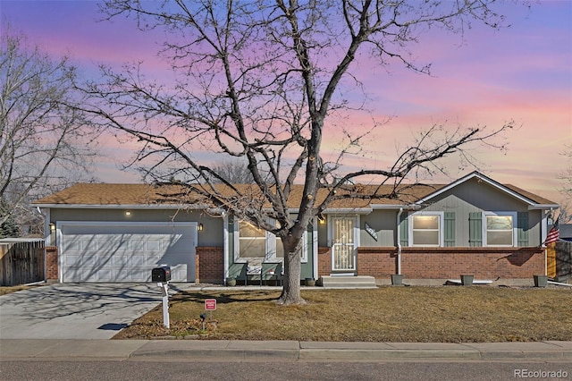 single story home with a garage, brick siding, driveway, and fence