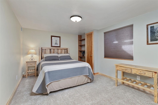 bedroom featuring carpet floors and baseboards