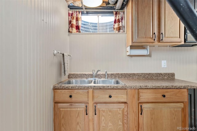 kitchen with light brown cabinets and a sink