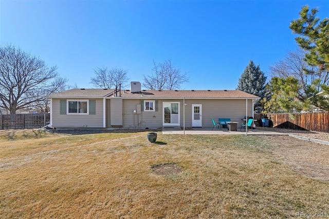 back of house featuring a patio area, a fenced backyard, and a yard