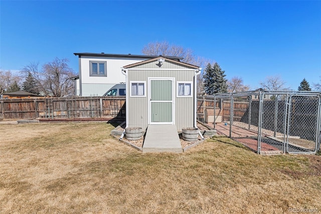 view of outdoor structure with a fenced backyard and an outdoor structure