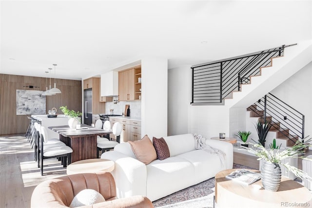 living room featuring wood walls and light hardwood / wood-style floors