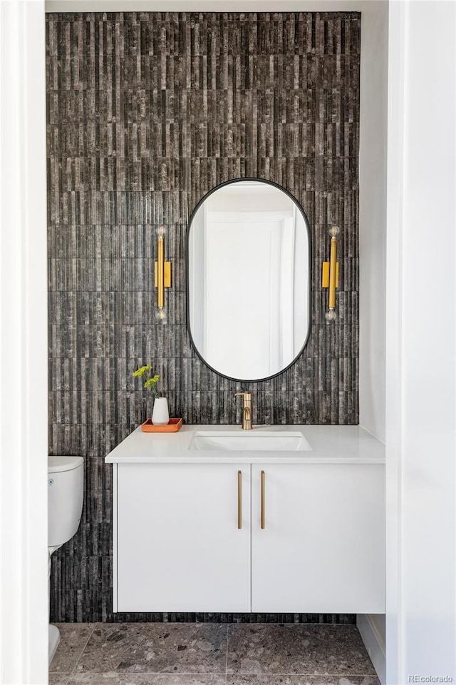 bathroom featuring vanity and toilet