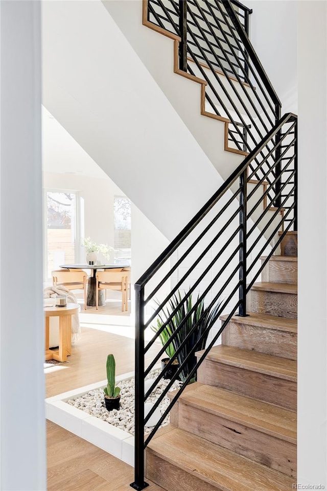 stairs featuring parquet flooring