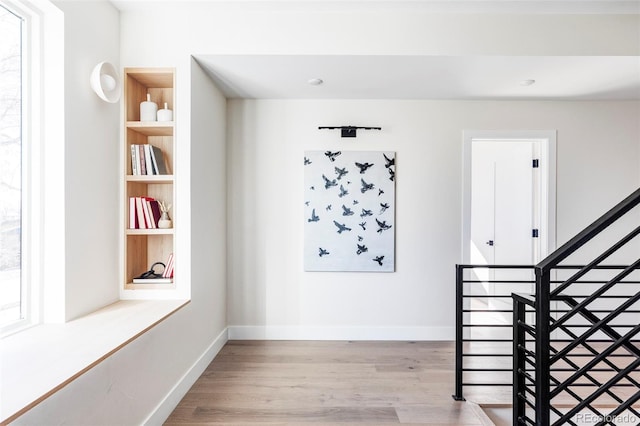 interior space featuring hardwood / wood-style floors and built in shelves