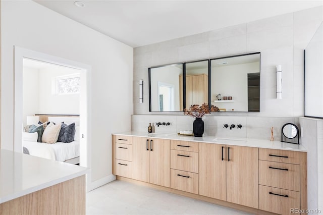 bathroom with decorative backsplash and vanity