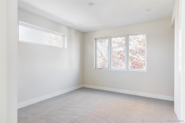 spare room featuring light carpet