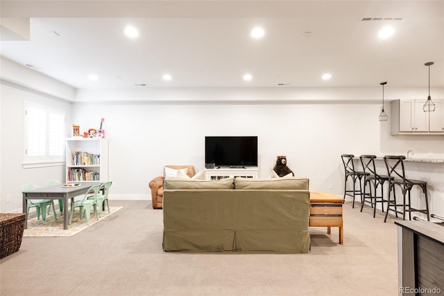 living room featuring recessed lighting, visible vents, light colored carpet, and baseboards