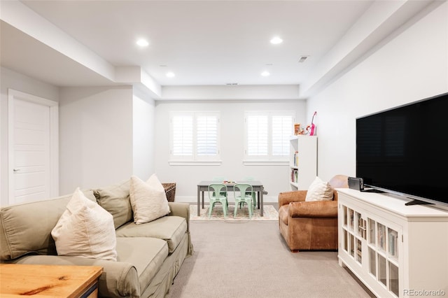 living room featuring recessed lighting, light colored carpet, and visible vents