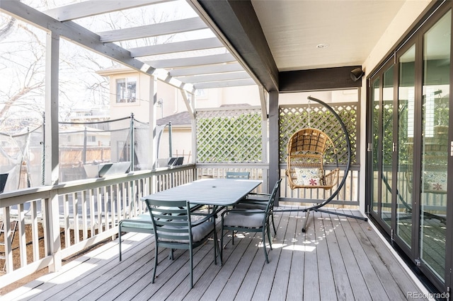 wooden deck featuring outdoor dining space and a pergola