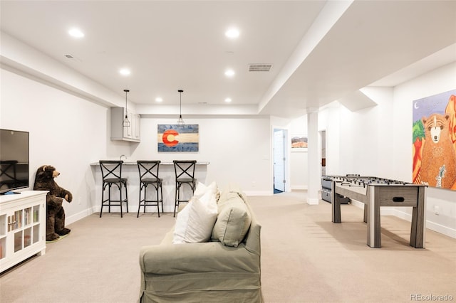 living area with bar area, recessed lighting, light colored carpet, and visible vents