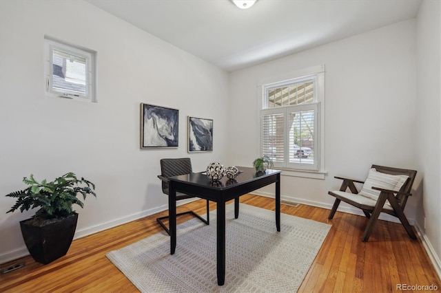 office area with healthy amount of natural light, light wood-style floors, and baseboards