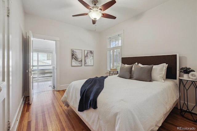 bedroom featuring wood-type flooring, baseboards, and ceiling fan