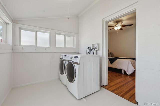 laundry area with washing machine and clothes dryer, ceiling fan, and crown molding