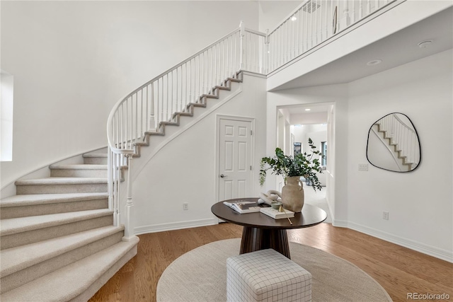 9566 Poppy Way, Arvada, CO 80007 - foyer entrance with a towering ceiling, stairs, and wood finished floors
