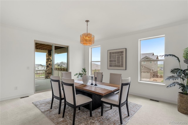 9566 Poppy Way, Arvada, CO 80007 - dining room featuring a chandelier, light colored carpet, and ornamental molding