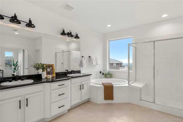 9566 Poppy Way, Arvada, CO 80007 - bathroom featuring a shower stall, double vanity, a bath, healthy amount of natural light, and recessed lighting