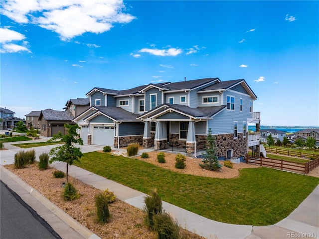 9566 Poppy Way, Arvada, CO 80007 - craftsman-style home with stone siding, a porch, concrete driveway, and a residential view
