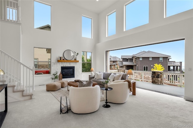9566 Poppy Way, Arvada, CO 80007 - carpeted living room with a fireplace, a high ceiling, healthy amount of natural light, and stairway