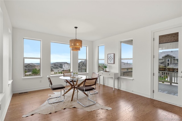 9566 Poppy Way, Arvada, CO 80007 - dining area featuring wood finished floors and healthy amount of natural light