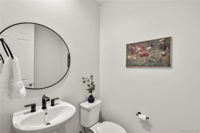 9566 Poppy Way, Arvada, CO 80007 - half bath with a sink and toilet