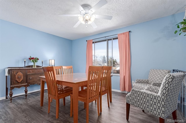 dining area featuring ceiling fan, baseboards, and wood finished floors