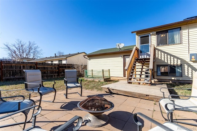 view of patio / terrace with stairway, a fire pit, and fence