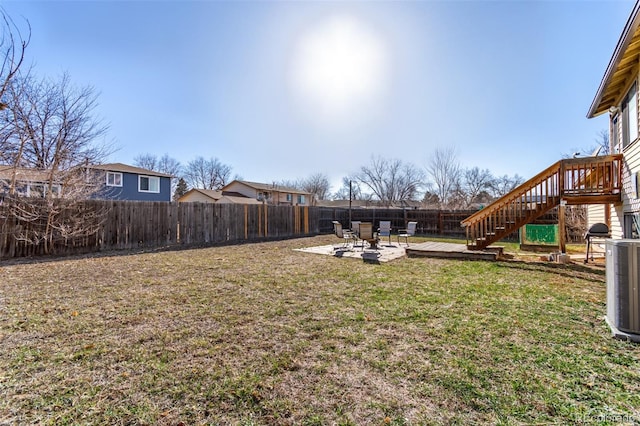 view of yard with stairway, a wooden deck, cooling unit, a fenced backyard, and a patio