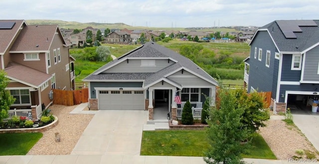 11817 Phoebe St, Parker, CO 80134 - craftsman house with concrete driveway, stone siding, a residential view, and roof with shingles