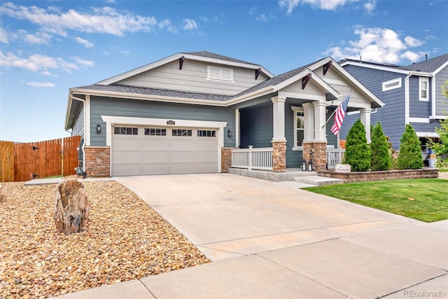 11817 Phoebe St, Parker, CO 80134 - craftsman-style house with a porch, a garage, stone siding, driveway, and roof with shingles