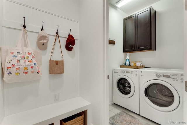 11817 Phoebe St, Parker, CO 80134 - laundry area with washing machine and dryer, light tile patterned floors, and cabinet space