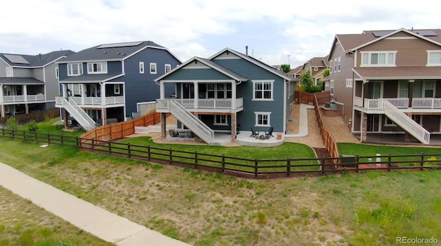 11817 Phoebe St, Parker, CO 80134 - rear view of house with stairway, a fenced backyard, a patio, and a residential view