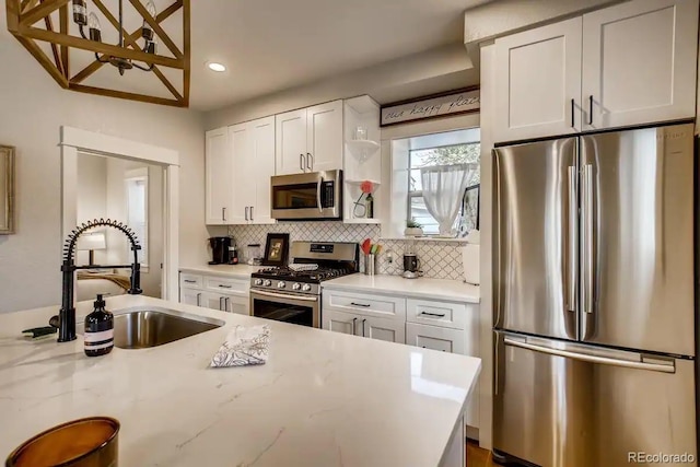 5123 W 41st Ave, Denver, CO 80212 - kitchen featuring stainless steel appliances, backsplash, recessed lighting, white cabinets, and light stone countertops