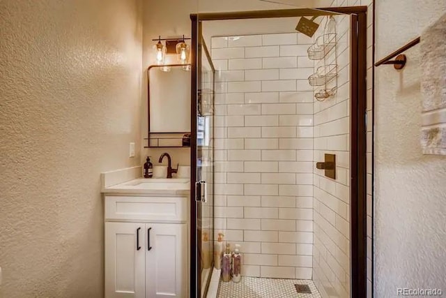 5123 W 41st Ave, Denver, CO 80212 - full bathroom featuring a textured wall, a stall shower, and vanity