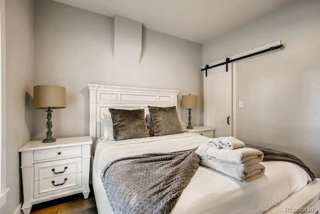 5123 W 41st Ave, Denver, CO 80212 - bedroom with a barn door and dark wood finished floors