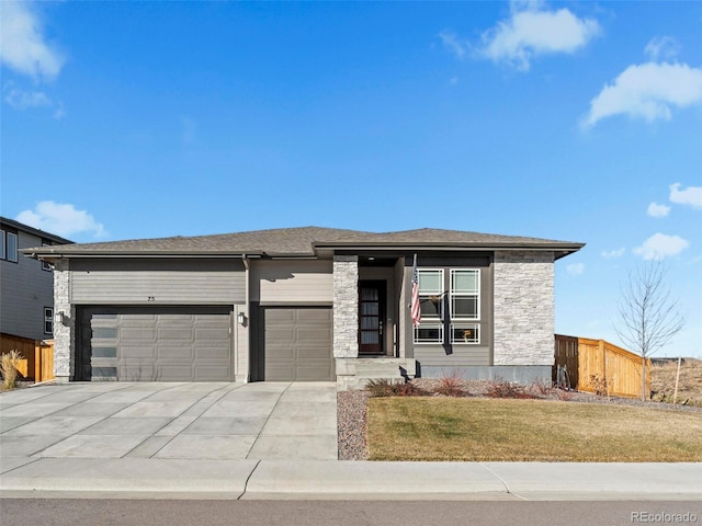 view of front of house with a garage and a front lawn