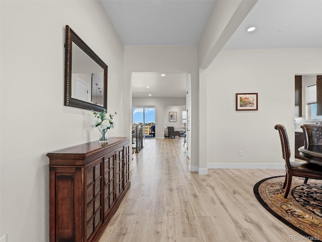 hallway with light hardwood / wood-style floors