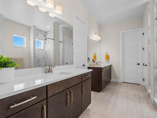 bathroom featuring a shower with door, vanity, and tile patterned flooring