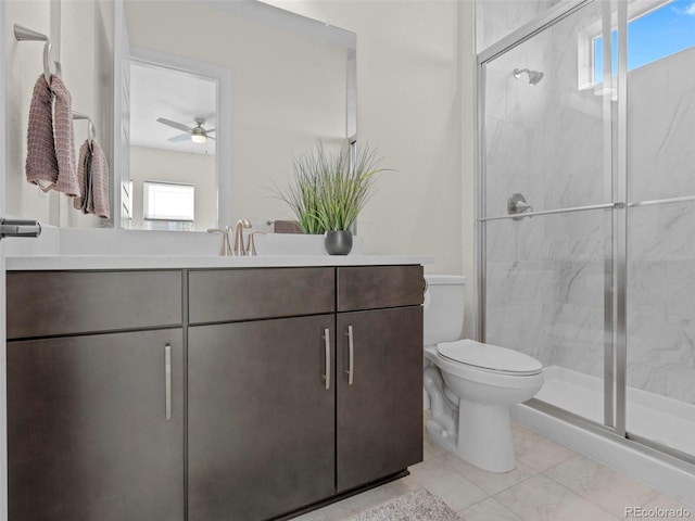 bathroom with ceiling fan, tile patterned flooring, toilet, vanity, and a shower with shower door