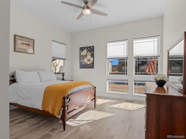 bedroom with ceiling fan and light hardwood / wood-style floors