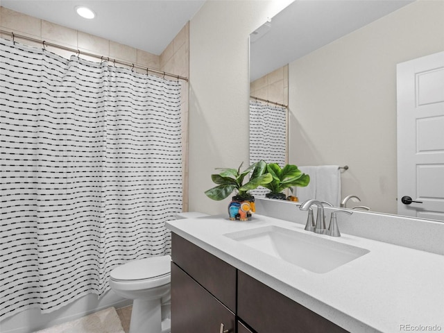 bathroom featuring toilet, vanity, and a shower with shower curtain