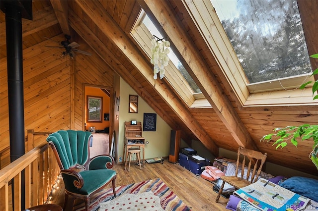 interior space featuring wooden ceiling, light hardwood / wood-style flooring, lofted ceiling with skylight, and ceiling fan