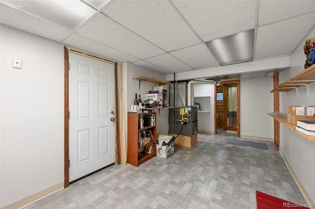 basement featuring a drop ceiling