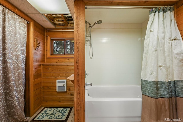 bathroom featuring shower / bath combo with shower curtain and wooden walls