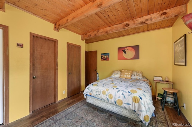 bedroom with dark wood-type flooring, two closets, beamed ceiling, and wood ceiling