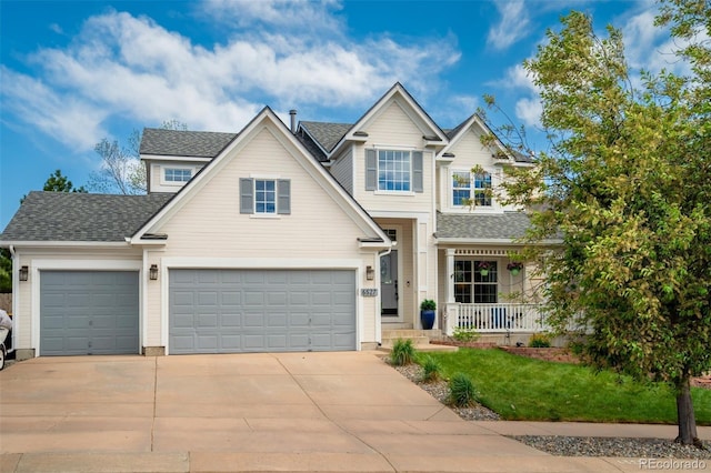 view of front of home with covered porch, driveway, a shingled roof, an attached garage, and a front yard