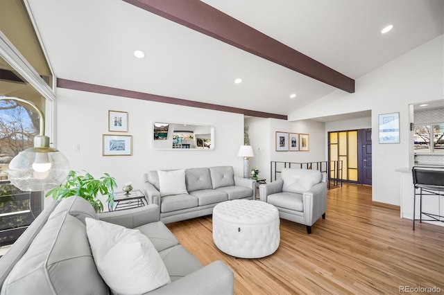 living area featuring recessed lighting, light wood-style flooring, and vaulted ceiling with beams