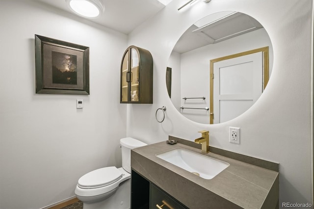 bathroom featuring toilet and vanity